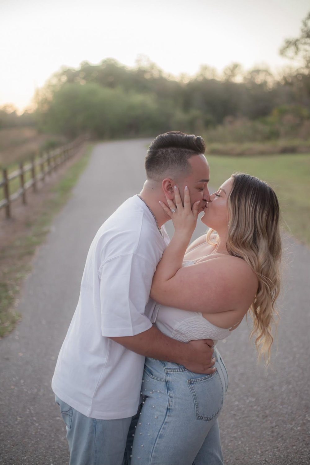 A kiss on a quiet garden path at sunset